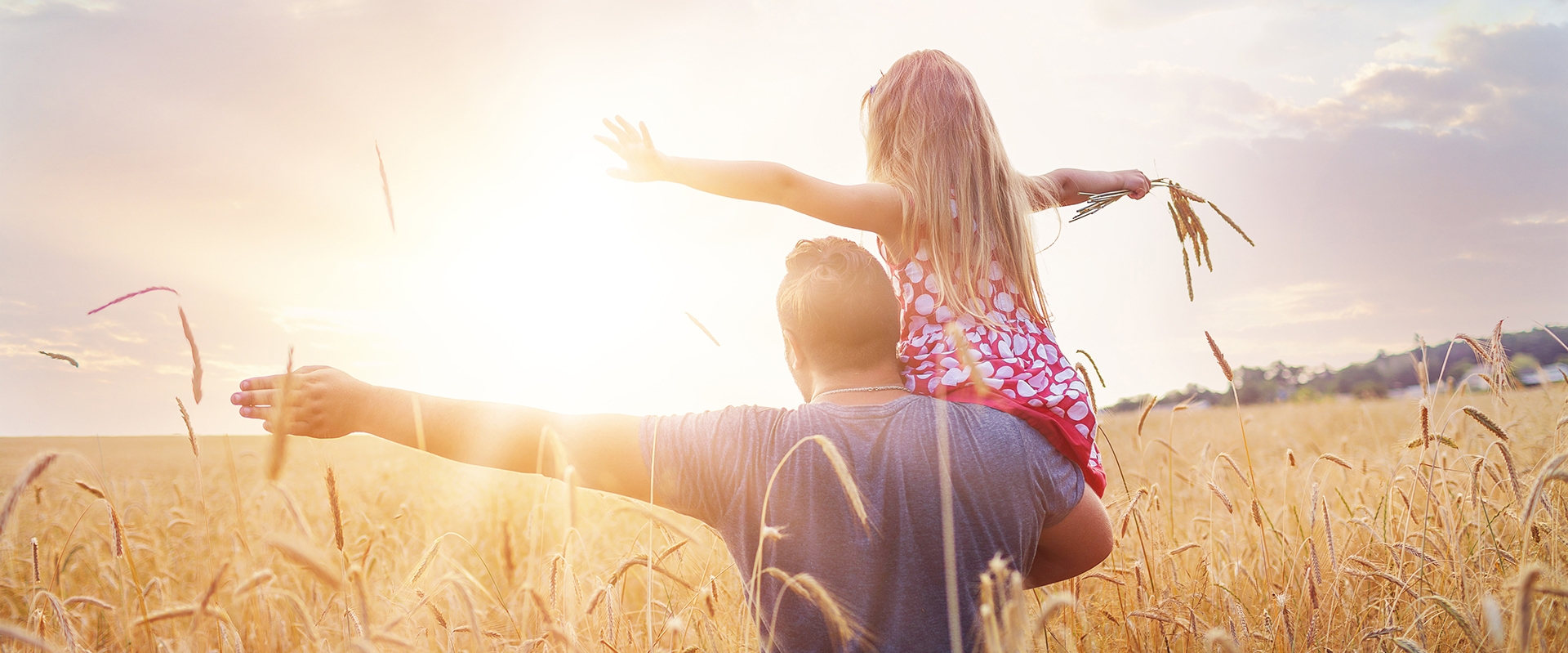 father and daughter in wheat field